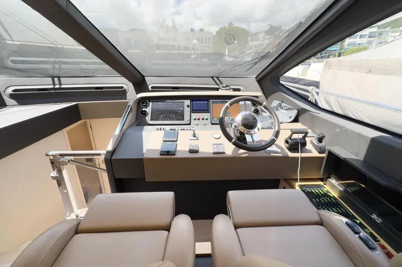  Yacht Photos Pics Luxurious helm of 2017 Azimut 66 yacht with modern navigation equipment and leather seating.