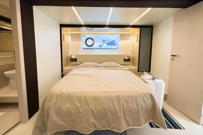  Yacht Photos Pics Luxurious bedroom interior of 2017 Azimut 66 yacht, featuring modern design and cozy ambiance.