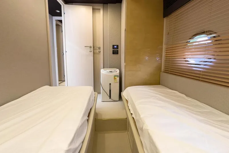  Yacht Photos Pics Twin cabin interior of 2017 Azimut 66 yacht with modern decor and porthole window.