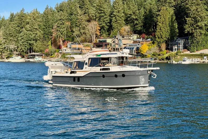 Bon Courage Yacht Photos Pics 2018 Ranger Tugs R-29 CB cruising on a scenic lake with forested shoreline.