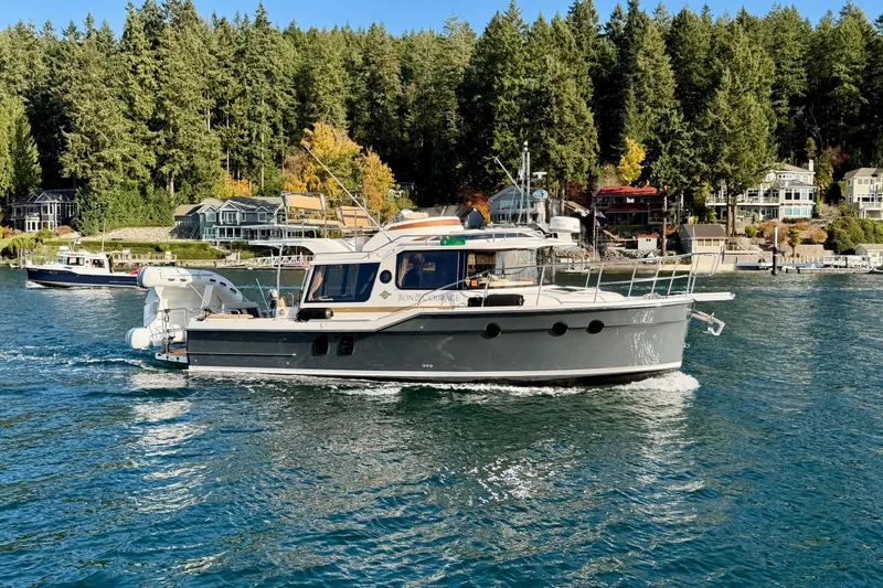 Bon Courage Yacht Photos Pics 2018 Ranger Tugs R-29 CB cruising on a scenic lake with forested shoreline.