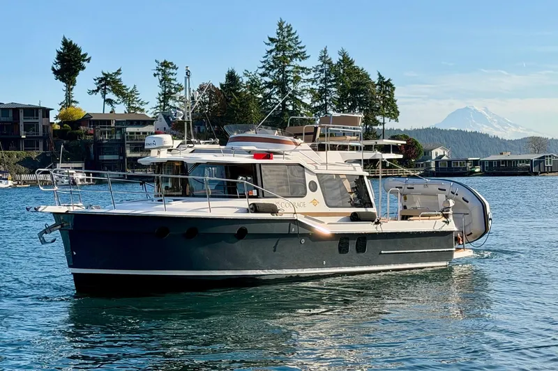 Bon Courage Yacht Photos Pics 2018 Ranger Tugs R-29 CB boat on scenic water with mountain backdrop.