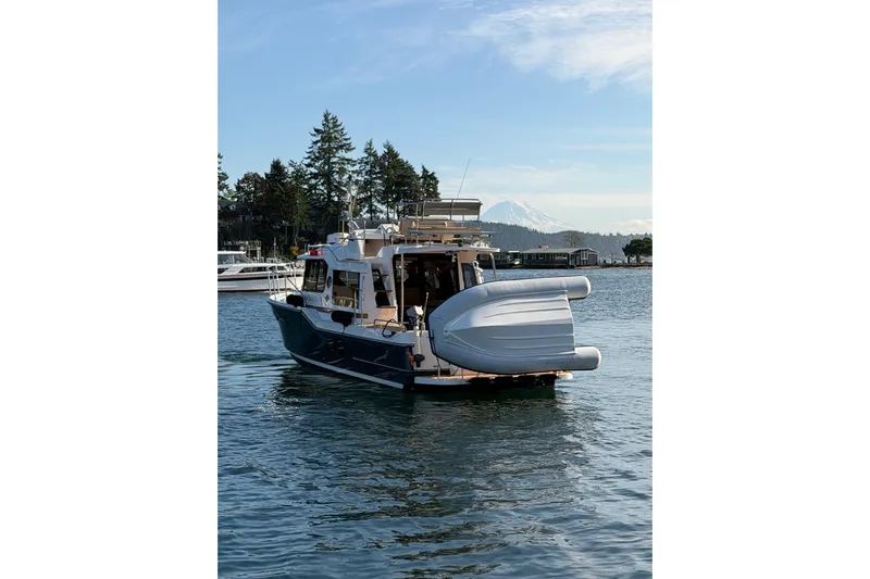 Bon Courage Yacht Photos Pics 2018 Ranger Tugs R-29 CB boat on serene water with scenic background.