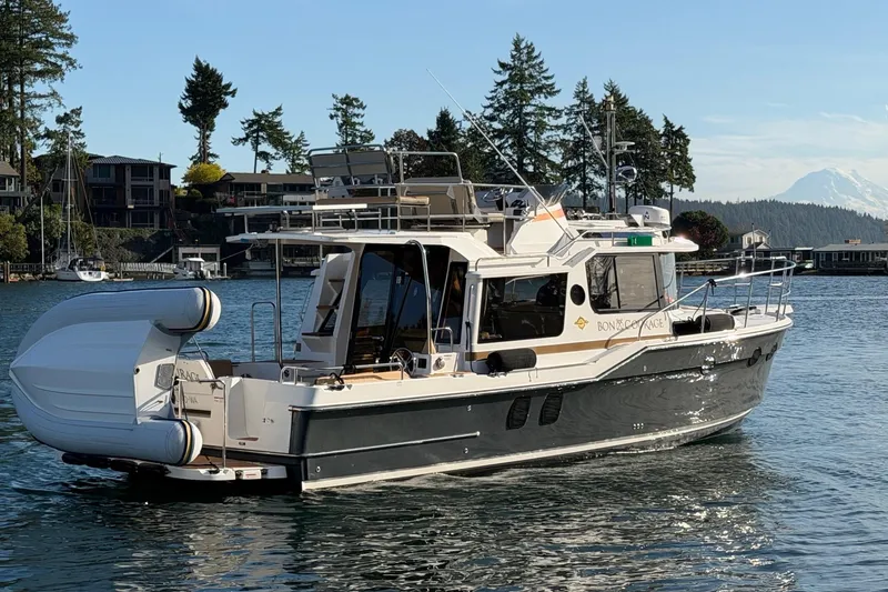 Bon Courage Yacht Photos Pics 2018 Ranger Tugs R-29 CB cruising on a scenic waterway with trees and mountains.