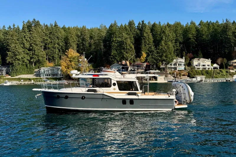 Bon Courage Yacht Photos Pics 2018 Ranger Tugs R-29 CB boat cruising on a scenic lake with forested shoreline.