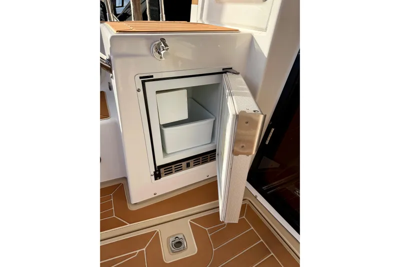 Bon Courage Yacht Photos Pics Open refrigerator on 2018 Ranger Tugs R-29 CB boat, showcasing interior storage space.