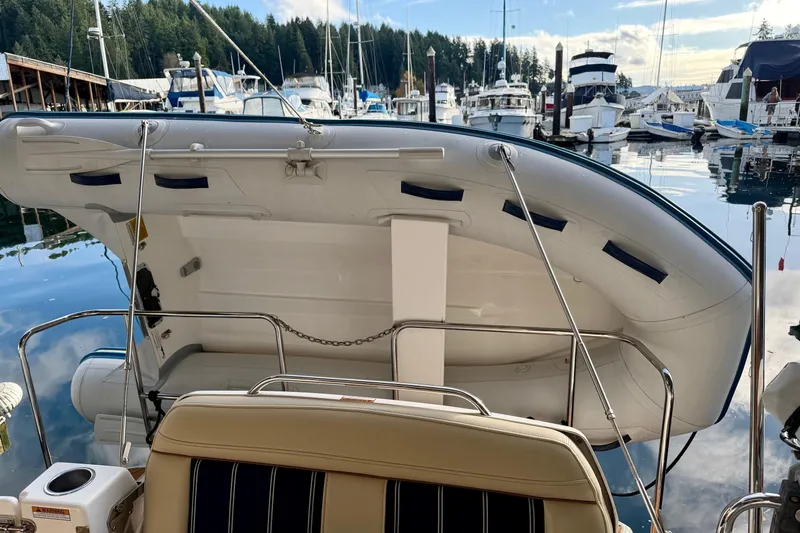 Bon Courage Yacht Photos Pics 2018 Ranger Tugs R-29 CB with dinghy, docked in a scenic marina setting.
