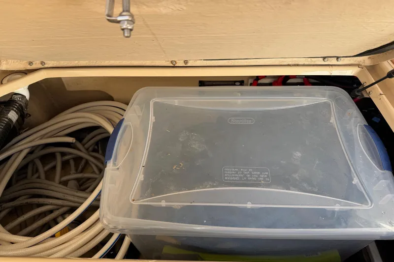 Bon Courage Yacht Photos Pics Storage compartment in 2018 Ranger Tugs R-29 CB with plastic container and coiled hoses.