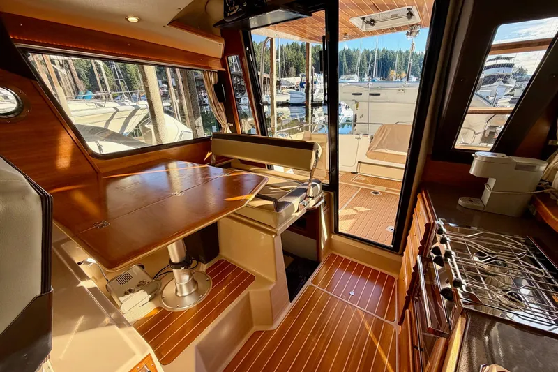 Bon Courage Yacht Photos Pics 2018 Ranger Tugs R-29 CB interior with wood finishes and marina view.