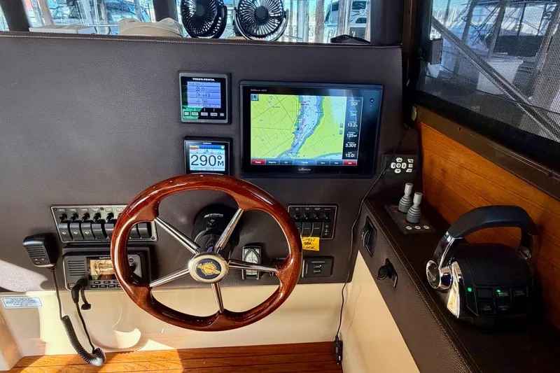 Bon Courage Yacht Photos Pics 2018 Ranger Tugs R-29 CB helm with navigation screens and wooden steering wheel.