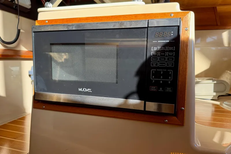 Bon Courage Yacht Photos Pics Microwave oven inside 2018 Ranger Tugs R-29 CB boat, featuring wood trim and digital controls.