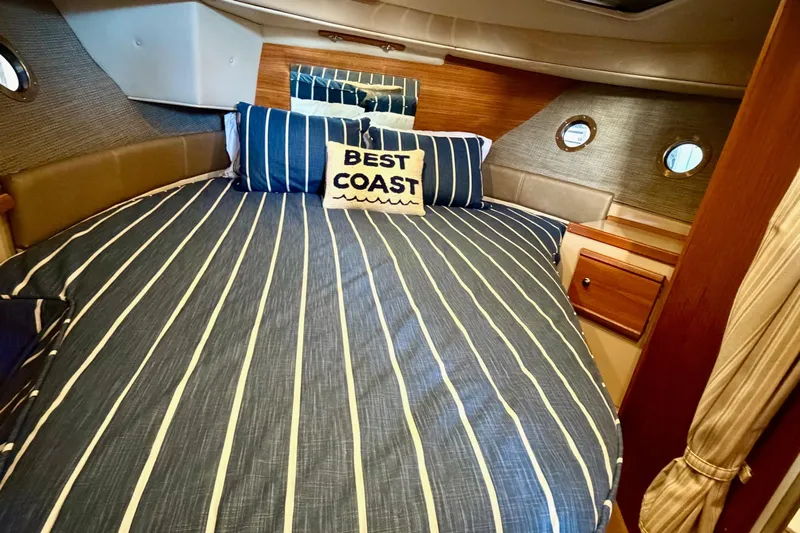 Bon Courage Yacht Photos Pics 2018 Ranger Tugs R-29 CB cabin with striped bedding and "Best Coast" pillow.