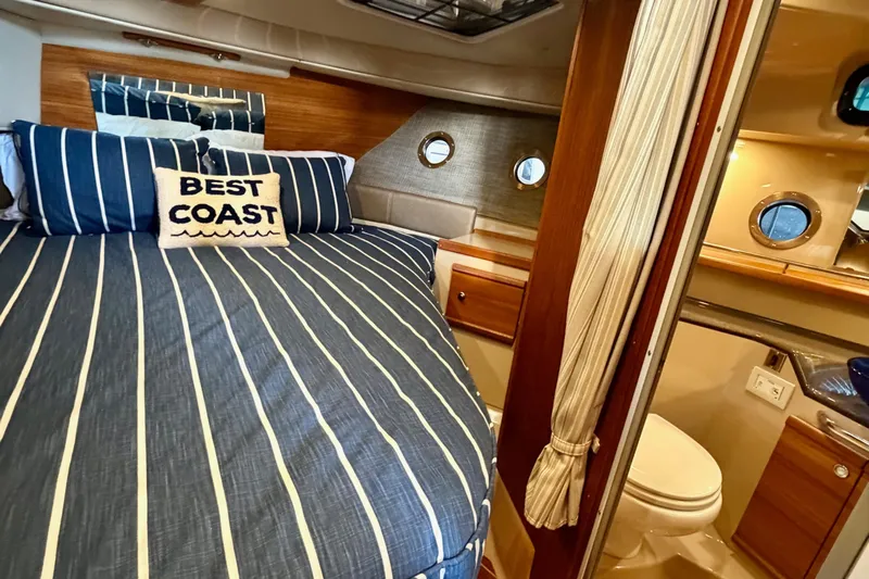 Bon Courage Yacht Photos Pics 2018 Ranger Tugs R-29 CB cabin interior with striped bedding and nautical decor.