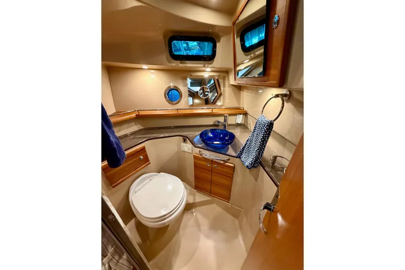 Bon Courage Yacht Photos Pics Luxurious 2018 Ranger Tugs R-29 CB bathroom with modern fixtures and elegant wood accents.