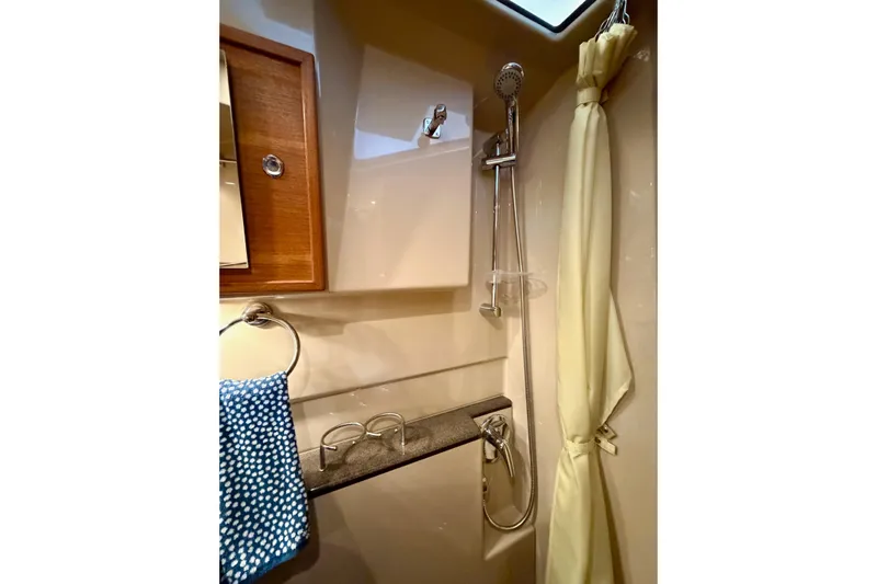 Bon Courage Yacht Photos Pics 2018 Ranger Tugs R-29 CB bathroom with shower, curtain, and towel rack.