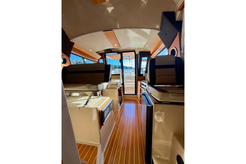 Bon Courage Yacht Photos Pics Interior of 2018 Ranger Tugs R-29 CB boat with wood flooring and seating.