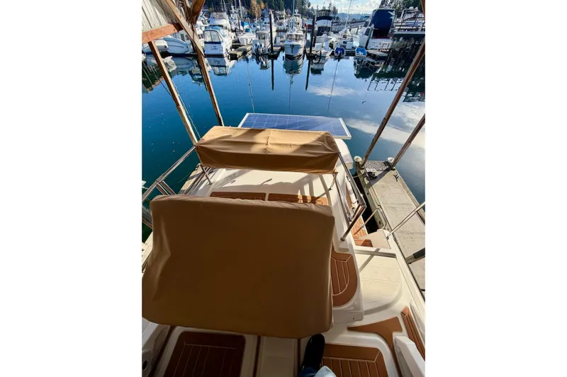 Bon Courage Yacht Photos Pics 2018 Ranger Tugs R-29 CB at marina, featuring solar panel and covered seating.