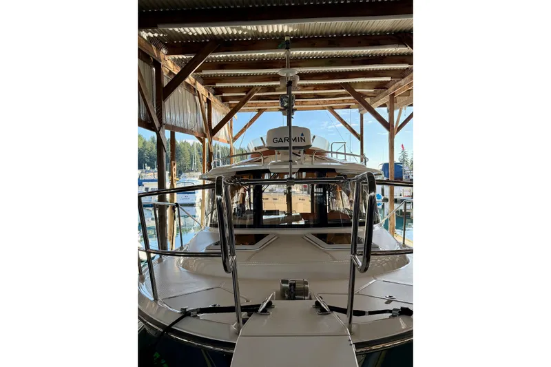 Bon Courage Yacht Photos Pics 2018 Ranger Tugs R-29 CB boat docked under a wooden shelter.