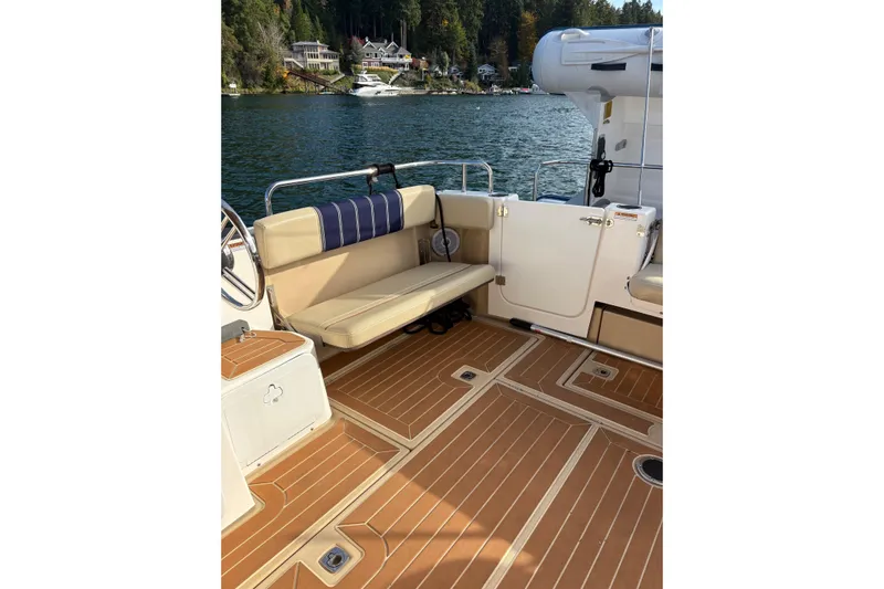 Bon Courage Yacht Photos Pics 2018 Ranger Tugs R-29 CB boat interior with tan seating and wood-style flooring.