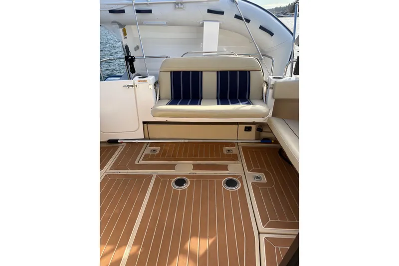 Bon Courage Yacht Photos Pics 2018 Ranger Tugs R-29 CB boat interior with cushioned seating and teak-style flooring.