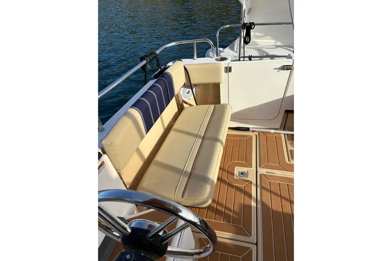 Bon Courage Yacht Photos Pics 2018 Ranger Tugs R-29 CB boat interior with tan seating and wooden deck.