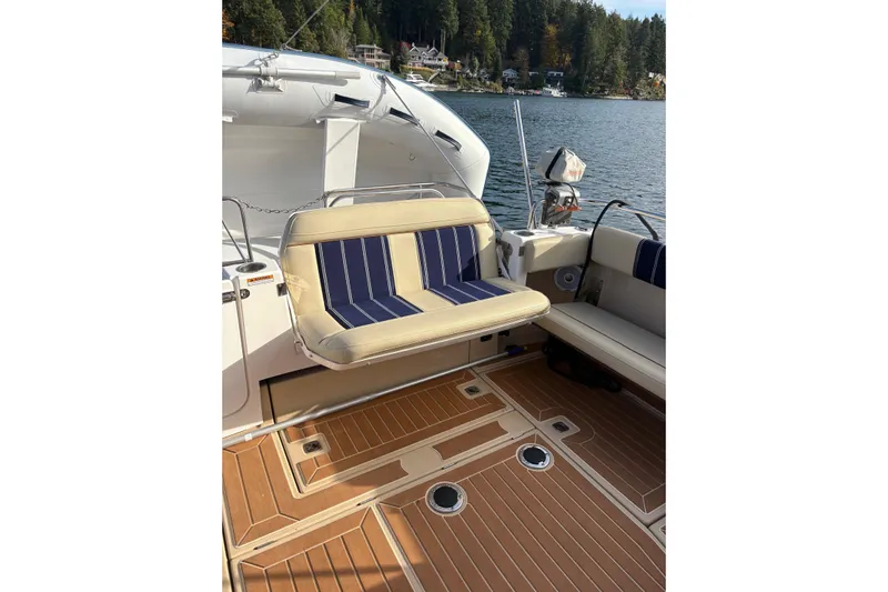 Bon Courage Yacht Photos Pics 2018 Ranger Tugs R-29 CB boat interior with striped seating and wooden deck.