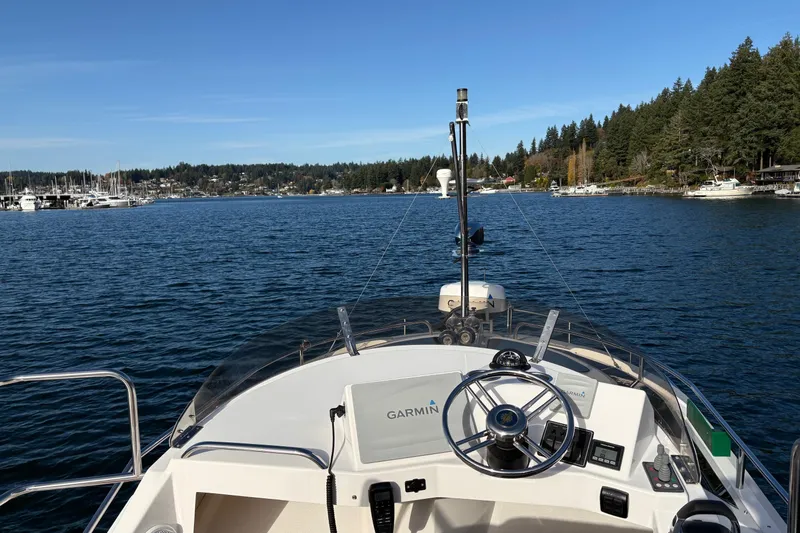 Bon Courage Yacht Photos Pics 2018 Ranger Tugs R-29 CB boat navigating scenic lake with forested shoreline.