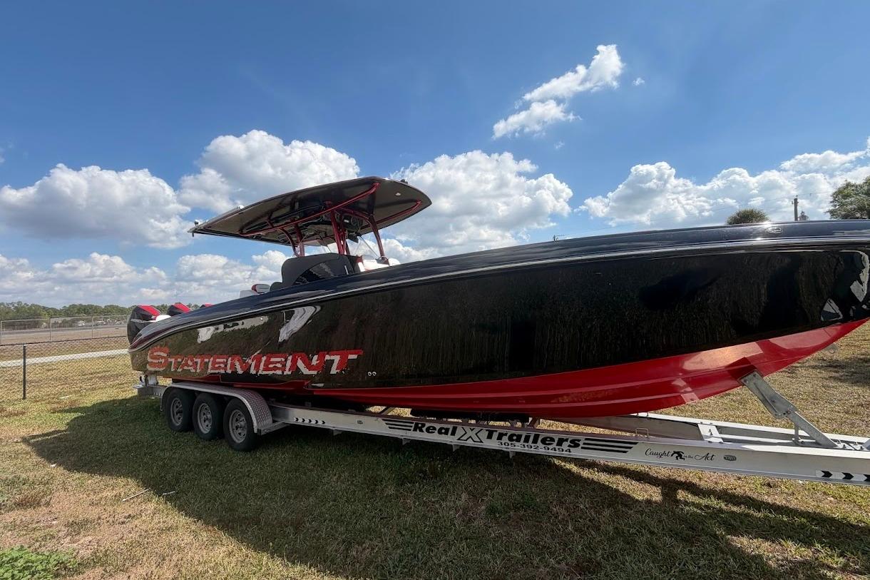 2018 Statement 380 Open boat on trailer under blue sky.