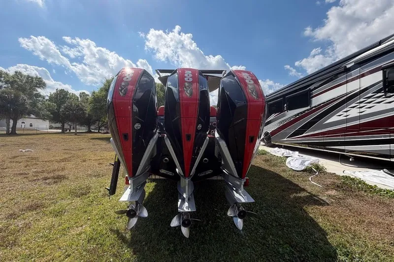  Yacht Photos Pics Four powerful outboard motors on a 2018 Statement 380 Open boat, parked on grass.
