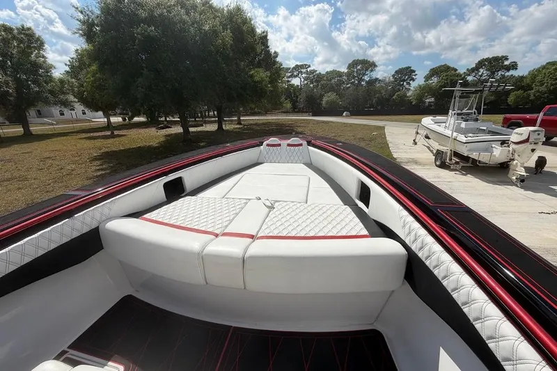  Yacht Photos Pics 2018 Statement 380 Open boat with luxurious seating, parked outdoors under a sunny sky.