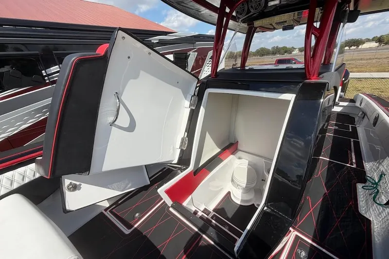  Yacht Photos Pics 2018 Statement 380 Open boat interior with open storage compartment, featuring sleek black and red design.