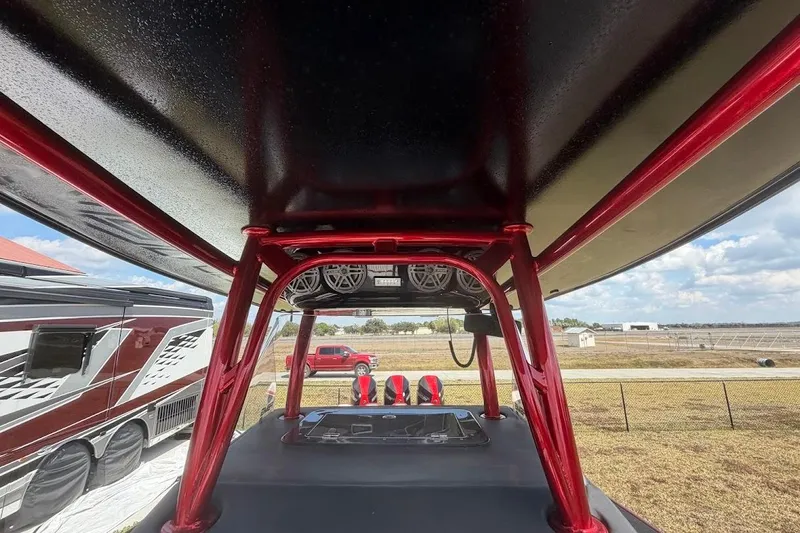  Yacht Photos Pics 2018 Statement 380 Open boat with red framework and speakers, parked near RV and open field.