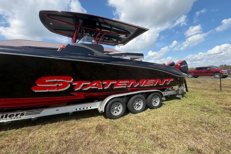  Yacht Photos Pics 2018 Statement 380 Open boat on trailer, black and red design, parked outdoors.