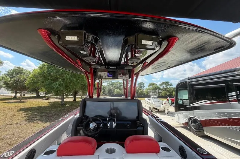  Yacht Photos Pics Interior view of 2018 Statement 380 Open boat with red accents and modern dashboard.