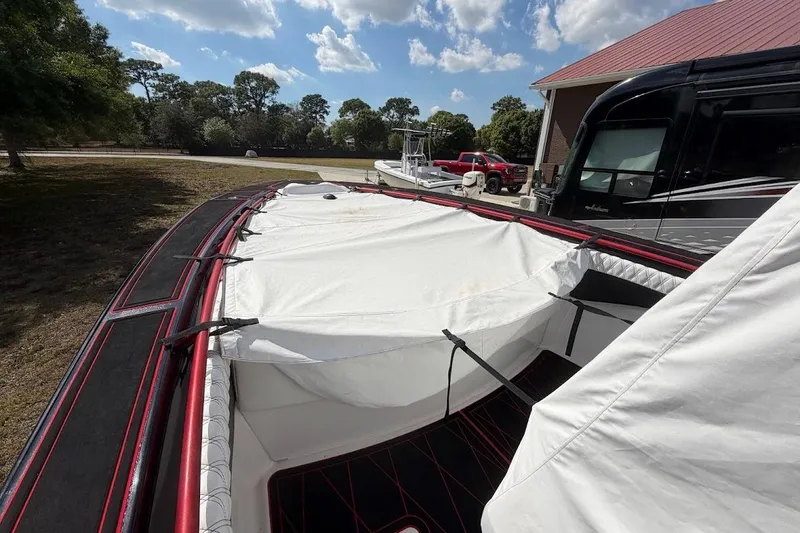 Yacht Photos Pics 2018 Statement 380 Open boat with cover, parked outdoors under a blue sky.