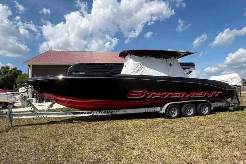  Yacht Photos Pics 2018 Statement 380 Open boat on trailer, parked outdoors under blue sky.