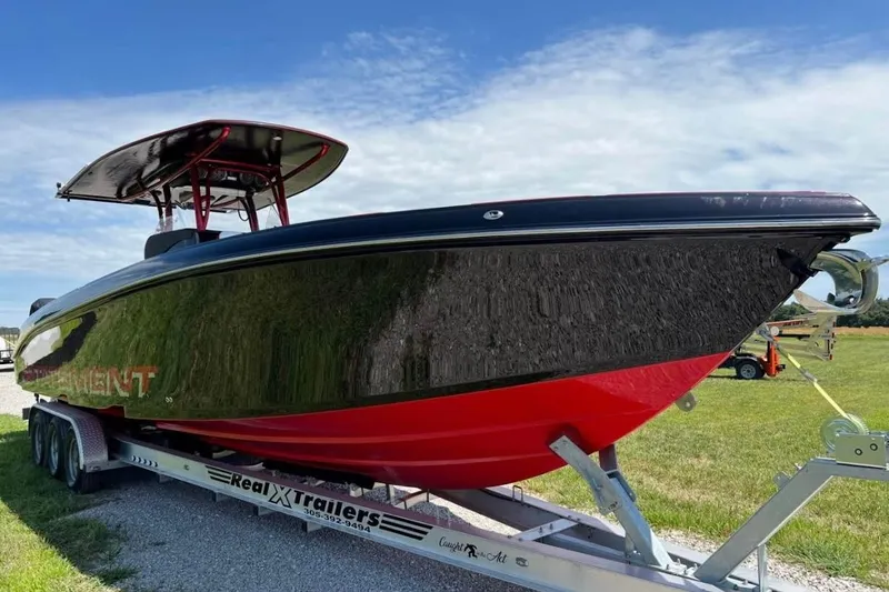  Yacht Photos Pics 2018 Statement 380 Open boat on trailer, black and red design, parked on grass.