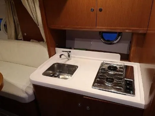  Yacht Photos Pics Compact kitchen area in 2016 Beneteau GT35 yacht with sink and stove.