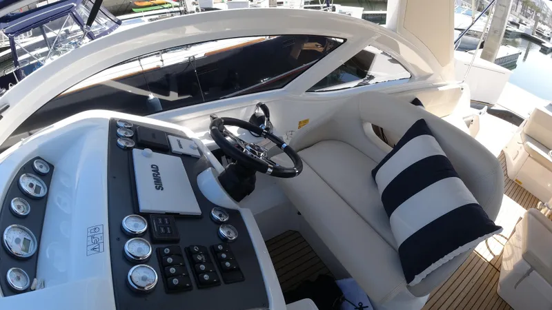  Yacht Photos Pics 2016 Beneteau GT35 yacht cockpit with steering wheel and cushioned seating.