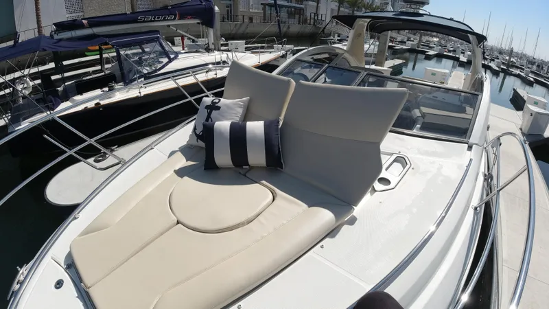  Yacht Photos Pics 2016 Beneteau GT35 yacht with sunbathing area and cushions docked at marina.
