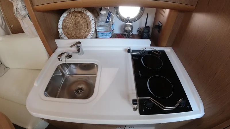  Yacht Photos Pics Compact kitchen area in a 2016 Beneteau GT35 yacht with sink and stove.