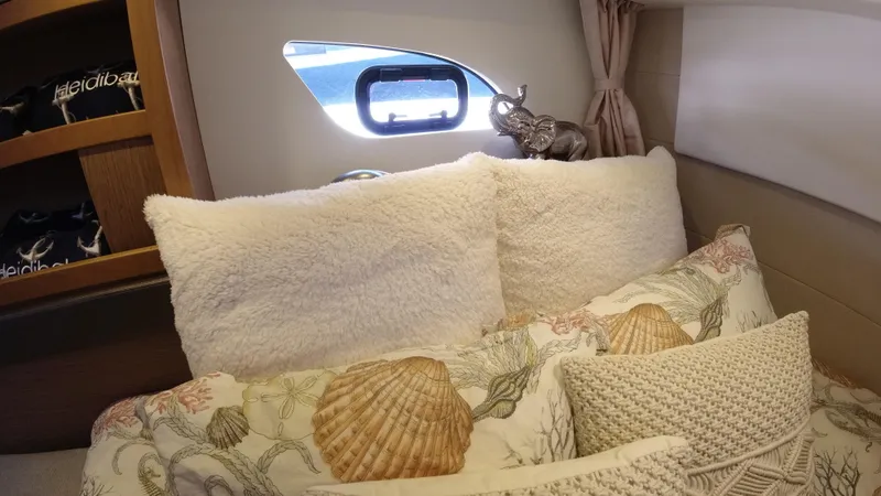  Yacht Photos Pics Cozy bedroom interior of 2016 Beneteau GT35 yacht with plush pillows and seashell-themed bedding.