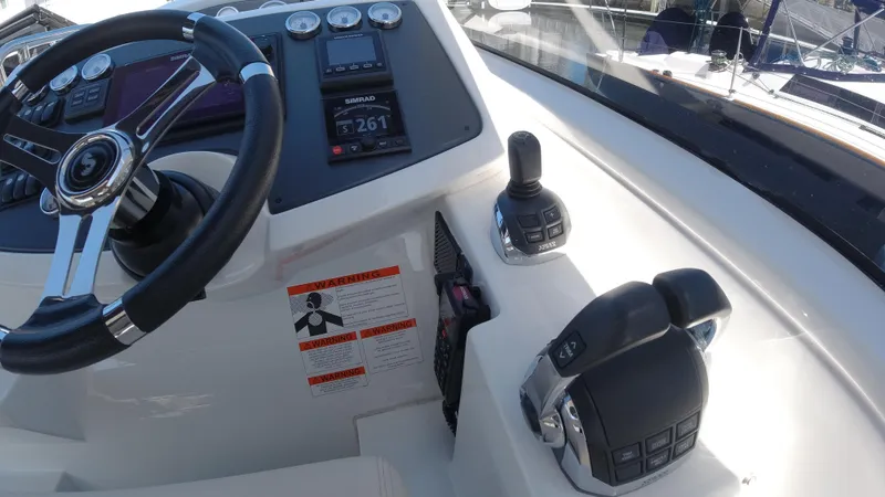  Yacht Photos Pics 2016 Beneteau GT35 helm station with steering wheel and control panel.