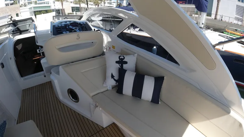  Yacht Photos Pics 2016 Beneteau GT35 yacht interior with white seating and nautical-themed pillows.