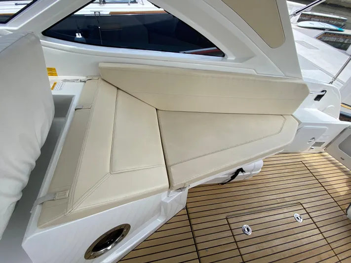 Yacht Photos Pics 2016 Beneteau GT35 boat interior with beige leather seating and teak flooring.