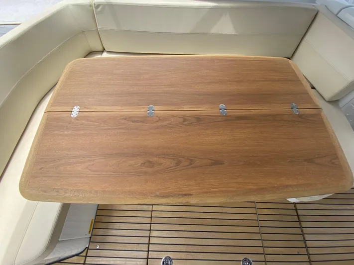  Yacht Photos Pics Wooden table and seating area on a 2016 Beneteau GT35 yacht.