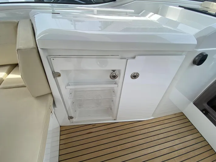  Yacht Photos Pics 2016 Beneteau GT35 yacht interior with white cabinetry and teak flooring.