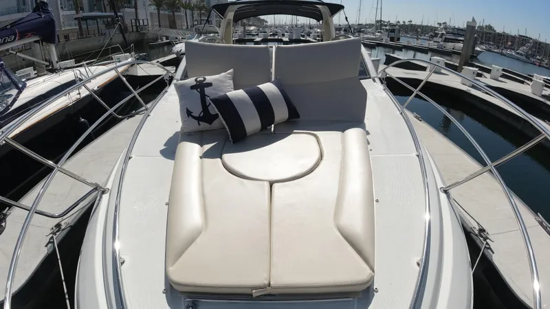  Yacht Photos Pics 2016 Beneteau GT35 yacht with sunbathing deck and nautical-themed cushions in a marina.
