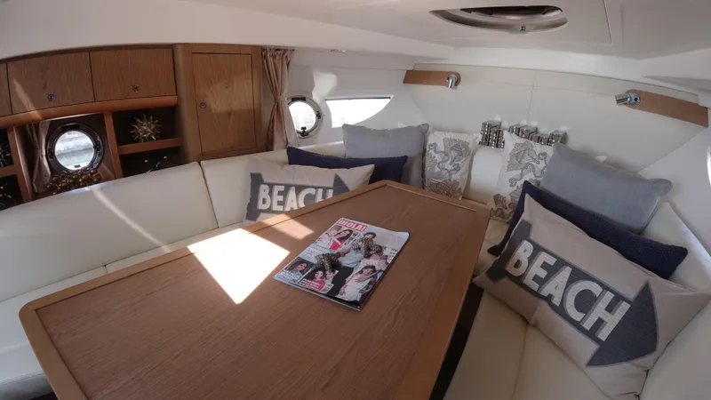  Yacht Photos Pics Interior of 2016 Beneteau GT35 yacht with cozy seating and decorative pillows.