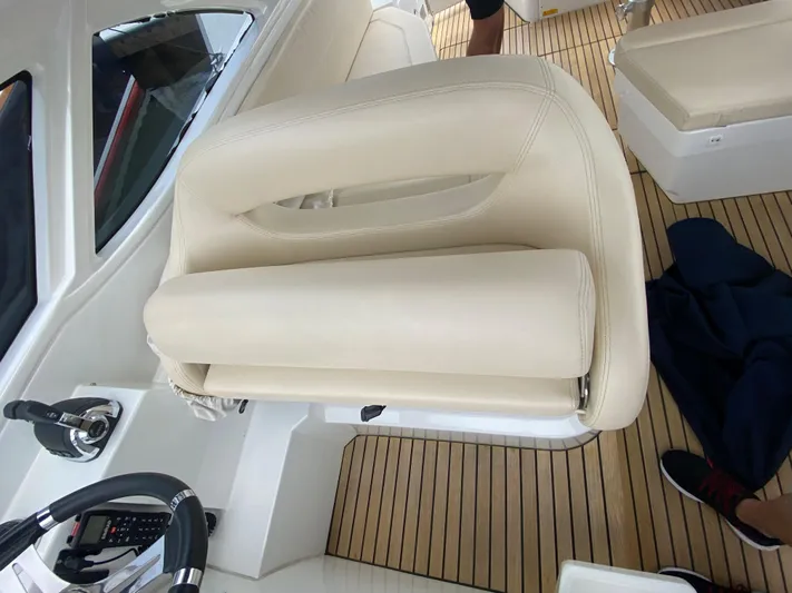  Yacht Photos Pics Captain's seat on a 2016 Beneteau GT35 yacht with teak flooring.